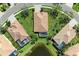 Aerial view of a home surrounded by a manicured lawn, screened lanai, and serene pond at 428 Grand Preserve Cv, Bradenton, FL 34212