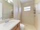 Well-maintained bathroom with tiled shower and a matching vanity with a sink and mirror at 428 Grand Preserve Cv, Bradenton, FL 34212