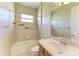Well-lit bathroom featuring a shower and bathtub combination with a coordinated vanity area at 428 Grand Preserve Cv, Bradenton, FL 34212