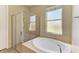 Modern bathroom features a large soaking tub and a separate glass-enclosed shower at 428 Grand Preserve Cv, Bradenton, FL 34212