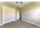 Neutral bedroom with closet, modern ceiling fan, plank floors and a light neutral color palette at 428 Grand Preserve Cv, Bradenton, FL 34212