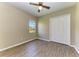 Cozy bedroom with ceiling fan, double door closet, plank floors, and a bright window at 428 Grand Preserve Cv, Bradenton, FL 34212
