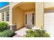 Inviting entryway featuring stone accents, a covered porch, and a bright front door at 428 Grand Preserve Cv, Bradenton, FL 34212
