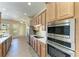 Kitchen with stainless steel appliances, wood cabinets, and wood-look flooring at 428 Grand Preserve Cv, Bradenton, FL 34212