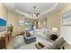 Comfortable living room with a ceiling fan, nice furniture, and a view of the lake at 428 Grand Preserve Cv, Bradenton, FL 34212