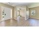 Inviting living room with hardwood floors, a bright window, and an open doorway at 428 Grand Preserve Cv, Bradenton, FL 34212