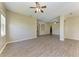 Spacious living area with wood-look floors and arched doorways at 428 Grand Preserve Cv, Bradenton, FL 34212