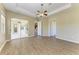 Main bedroom with a ceiling fan, hardwood floors, and sliding glass doors that lead to the lanai at 428 Grand Preserve Cv, Bradenton, FL 34212