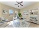 Real estate image of a bright home office with modern decor, a desk, and a bookshelf at 428 Grand Preserve Cv, Bradenton, FL 34212