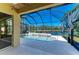 Relaxing screened-in pool area with a lovely view of the adjacent lake at 428 Grand Preserve Cv, Bradenton, FL 34212