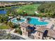 Aerial view of resort-style pool and surrounding golf course in community at 428 Grand Preserve Cv, Bradenton, FL 34212