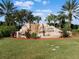 Beautiful community entrance with stone waterfall and lush landscaping at 428 Grand Preserve Cv, Bradenton, FL 34212