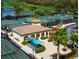Aerial view of multiple tennis courts and landscaped clubhouse in the community at 428 Grand Preserve Cv, Bradenton, FL 34212