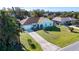 An aerial view of a single story home with a nice lawn, driveway, palm trees and a view of neighborhood homes at 4360 Flamingo Blvd, Port Charlotte, FL 33948