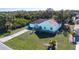 An aerial view of a single story home, landscaped yard, driveway, and surrounding neighborhood at 4360 Flamingo Blvd, Port Charlotte, FL 33948
