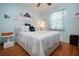 Nautical themed bedroom with hard wood floors, large bed, nautical decor, and a ceiling fan at 4360 Flamingo Blvd, Port Charlotte, FL 33948