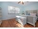Bright bedroom with hardwood floors, a decorative chest, and a large window at 4360 Flamingo Blvd, Port Charlotte, FL 33948