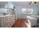 Bright bedroom with white furniture, wood floors, and plenty of natural light from the window at 4360 Flamingo Blvd, Port Charlotte, FL 33948