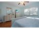 Bedroom with hardwood floors, a ceiling fan, a TV, and white furnishings at 4360 Flamingo Blvd, Port Charlotte, FL 33948