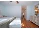 Bright bedroom with wood floors, ceiling fan, white furniture, and access to hallway and closet at 4360 Flamingo Blvd, Port Charlotte, FL 33948