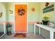 A brightly colored front door with decorative decor, including a wreath and 