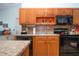 Charming kitchen with vaulted ceilings and sleek black appliances and granite countertops at 4360 Flamingo Blvd, Port Charlotte, FL 33948