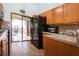 Bright kitchen features granite countertops, wood cabinets and stainless steel appliances, with screened patio access at 4360 Flamingo Blvd, Port Charlotte, FL 33948