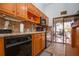 Well-lit kitchen with wooden cabinets, tile backsplash, and patio access at 4360 Flamingo Blvd, Port Charlotte, FL 33948