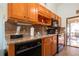 Functional kitchen featuring wooden cabinets, tile backsplash, and stainless steel appliances at 4360 Flamingo Blvd, Port Charlotte, FL 33948