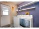 Laundry area featuring a white washer and dryer set with decorative shelves above at 4360 Flamingo Blvd, Port Charlotte, FL 33948