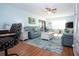 Open-concept living room with hardwood floors, comfortable blue sofas, and coastal decorations at 4360 Flamingo Blvd, Port Charlotte, FL 33948