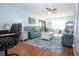Open-concept living room with hardwood floors, comfortable blue sofas, and coastal decorations at 4360 Flamingo Blvd, Port Charlotte, FL 33948