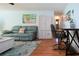 Cozy living room with wood floors, coastal accents, seating, and a decorative flamingo artwork at 4360 Flamingo Blvd, Port Charlotte, FL 33948