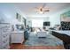 Inviting living room with modern seating, stylish rug, ceiling fan, and ample natural light at 4360 Flamingo Blvd, Port Charlotte, FL 33948