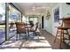 Inviting screened porch with dining set, ceiling fan, and views of the backyard at 4360 Flamingo Blvd, Port Charlotte, FL 33948