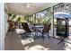 Relaxing screened porch with dining table, ceiling fan, and outdoor views at 4360 Flamingo Blvd, Port Charlotte, FL 33948