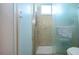 Tiled shower with glass doors, a shower head, handrail, and window at 4360 Flamingo Blvd, Port Charlotte, FL 33948