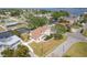 Aerial view of a waterfront home with a canal, boat dock, large trees, and a fenced yard at 4406 17Th W St, Palmetto, FL 34221