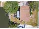 Aerial view of the home and boat dock with a brown roof, screened in porch, and lush landscaping at 4406 17Th W St, Palmetto, FL 34221