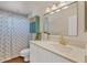 Charming bathroom with updated vanity, decorative mirror, and shower with patterned curtain at 4406 17Th W St, Palmetto, FL 34221