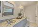 Bathroom featuring double sinks, updated cabinets, marble countertops and a shower/tub combo at 4406 17Th W St, Palmetto, FL 34221