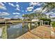 Private boat dock with boat lift and water access with blue skies in the background at 4406 17Th W St, Palmetto, FL 34221