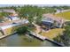 Waterfront property with a private boat dock, large tree, screened in porch, and lush landscaping at 4406 17Th W St, Palmetto, FL 34221