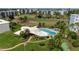 Aerial view of community pool, tennis courts, and well-maintained landscaping at 4440 Ironwood Cir # 509D, Bradenton, FL 34209