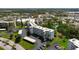 An elevated view displaying the residential building, covered parking, and tree-lined streets at 4440 Ironwood Cir # 509D, Bradenton, FL 34209
