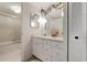 Well-lit bathroom with a shower, vanity with drawers, and floral decor at 4440 Ironwood Cir # 509D, Bradenton, FL 34209