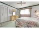 Cozy bedroom with floral bedding, dresser with mirror, and a ceiling fan at 4440 Ironwood Cir # 509D, Bradenton, FL 34209