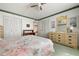 Spacious bedroom featuring multiple closets, a dresser, and floral bedding at 4440 Ironwood Cir # 509D, Bradenton, FL 34209