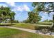 Expansive green space with mature trees and a paved path at 4440 Ironwood Cir # 509D, Bradenton, FL 34209