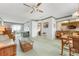 Inviting living room featuring wicker furniture, bright carpet, and a seamless flow to the balcony at 4440 Ironwood Cir # 509D, Bradenton, FL 34209